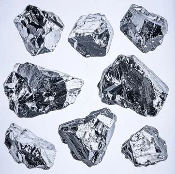A collection of rough raw diamonds in various natural shapes and sizes, iso.. Stock Photos