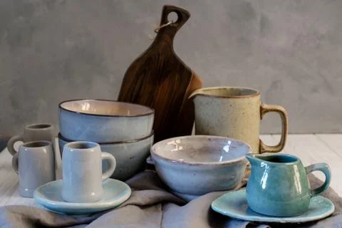 Collection of rustic simple handcraft kitchenware in neutral tones on grey Stock Photos