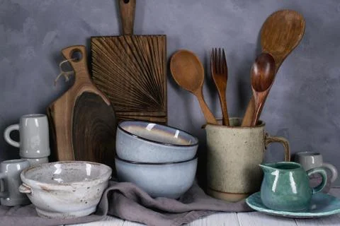 Collection of rustic simple handcraft kitchenware in neutral tones on grey Stock-Fotos