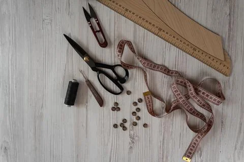 Collection of sewing tools and tailoring accessories including scissors, meas Stock Photos
