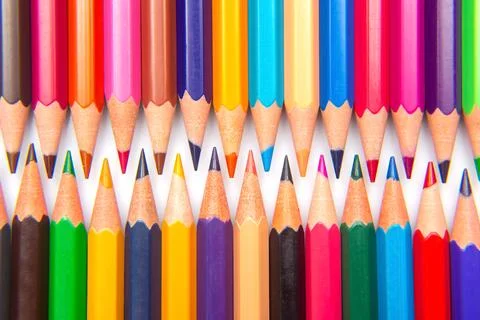 A collection of sharpened colored pencils in a grid pattern on a white back.. Stock Photos