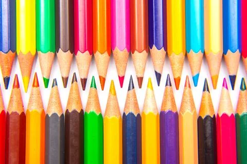 A collection of sharpened colored pencils in a grid pattern on a white back.. Stock Photos