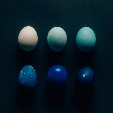 Collection of six colored painted easter eggs on dark surface 스톡 사진