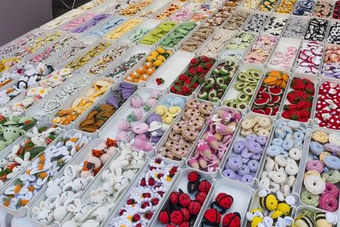 Collection of small handmade buttons and craft accessories displayed at a s.. Stock Photos