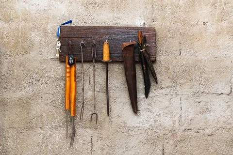 A collection of tools hanging on a wall Stock Photos
