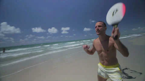 Collection - two gays Playing paddle ball at the beach Stock Footage