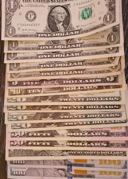 A collection of U.S. currency notes arranged in ascending order Stock Photos