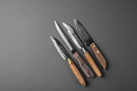 Collection of various kitchen knives on a grey background Stock Photos