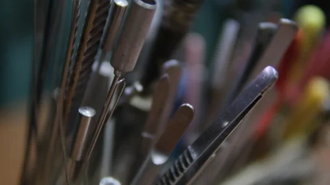 A collection of various metal tools with different handles, arranged closely Stock Footage 302572436