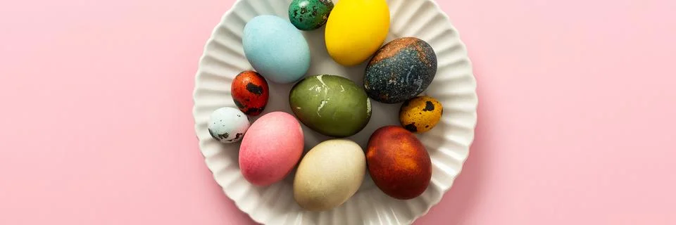 A collection of vibrant Easter eggs in various colors is artfully arranged .. Stock Photos