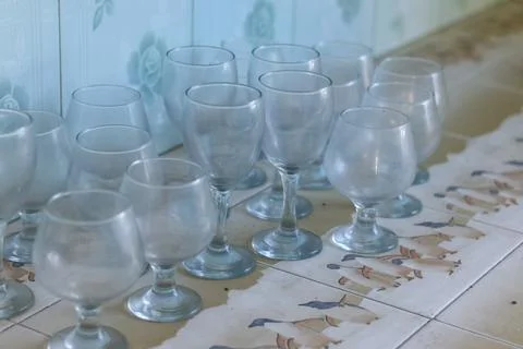Collection of Vintage Glass Goblets on Patterned Tiles Stock Photos