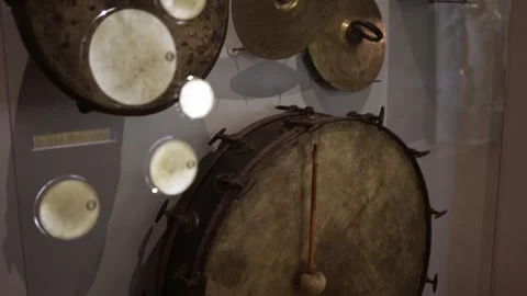 A collection of vintage percussion instruments displayed in a museum, including  Stock Footage 293565730