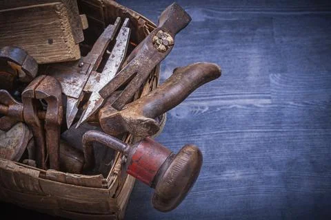Collection of vintage rough tools in wicker box construction concept Stock Photos