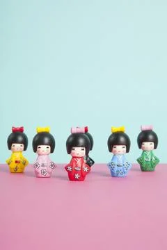 A collection of wooden kokeshi dolls arranged in a triangle like bowling sk.. Stock Photos