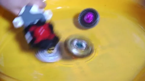 Collective image of the children's popular toy Beyblade. The battle of twcenter. Stock Footage