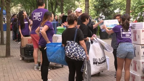College and university students heading back to school moving in to campus dorm Stock Footage