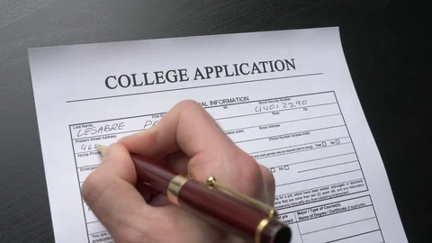 College Application Form Closeup Of Hand Hand Filling the Document Stock Footage 76437876
