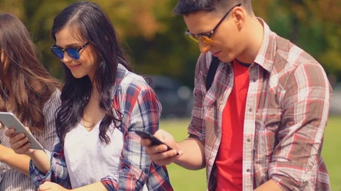 College friends using smartphone texting messages hanging out in city Video stock 130055491