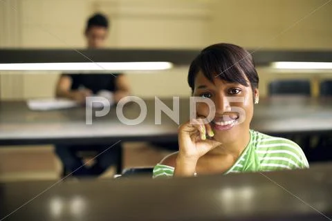 College library and female student, black woman looking at camera Stock Photos