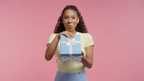 College or school stylish student girl with wrapped gift and warm smile. Special Stock Footage 346494615
