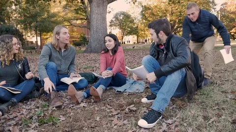 College student arriving to a study group and messing around with his friends Stock Footage 104299161