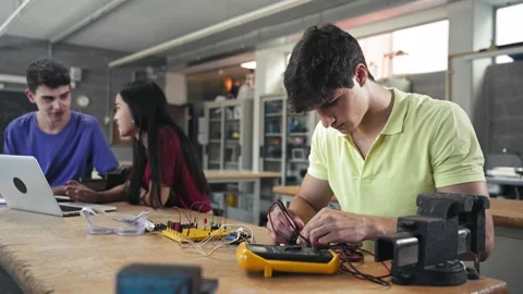 College Student building electronics circuit in the engineering technology Stock Footage 237986814
