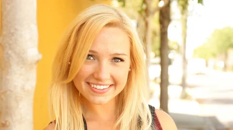 College student female smiling while walking into focus on campus Stock Footage 37372212