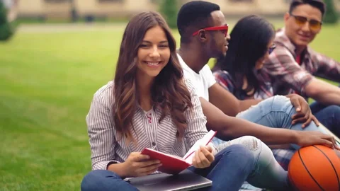 College student girl spend time with her friends and reading a book Video stock 127300341
