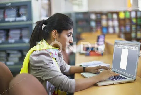 College Student With Laptop In Library