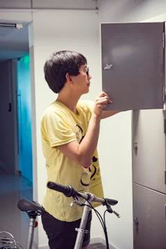 College student opening locker Stock Photos