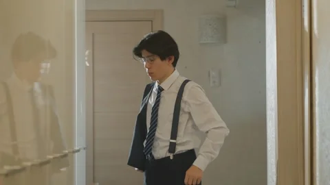 College student preparing. Young man readies himself in corridor mirror. Focused Stock Footage 337234271