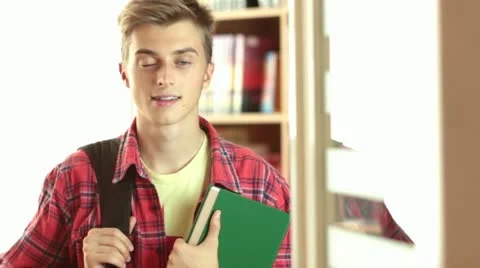College Student standing in the Library. Dolly shot. Video stock 11895337