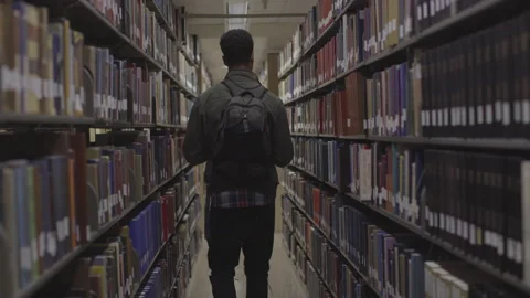 College Student Walking in Library Hall Stock Footage 208710745