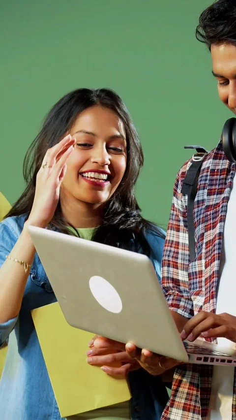 College students celebrate success while standing and using laptop for project Video stock 342385080