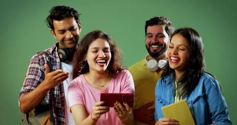 College students laugh watching video on mobile in group, standing Stock Footage 342383706