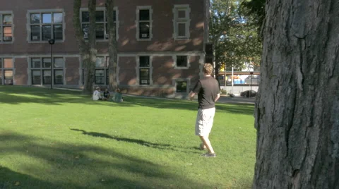 College Students Playing Frisbee on Lawn Stock Footage
