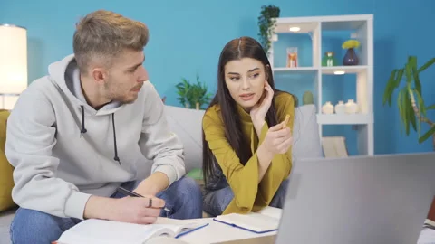 College students sitting together at table and using laptop. Video stock 228152332