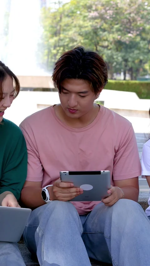 College Students Studying Together on Campus Steps with Laptop and Tablet Stock Footage 329010808