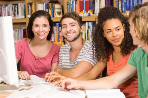 College students using computer in library 스톡 사진