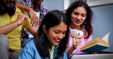 College students using laptop outdoors while completing assignment Stock Footage 342384715