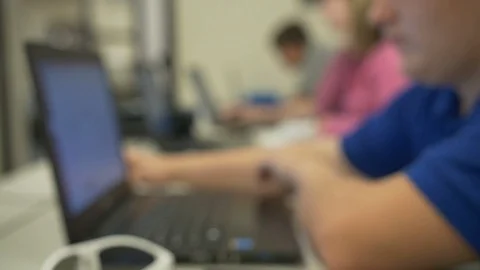 College Students Using Laptops In Classroom (Blurred for Graphic/text Overlay) Stock Footage 124341009
