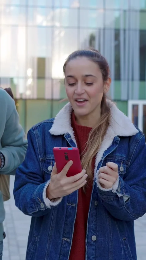 College students using mobile phone while walking at university campus. Stock Footage 310780264