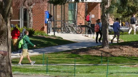 College Students Walking Around Busy Campus on Cool Spring Day Stock Footage