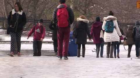 College students walking to school on snow and ice Stock Footage 37129986