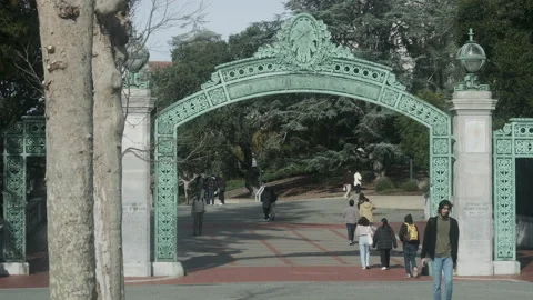 College students walking under Sather Gate at UC Berkeley. Slow motion Stock Footage 231217278