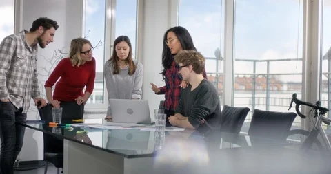 Colleges reviewing new idea from a young attractive employee Stock Footage 91931253