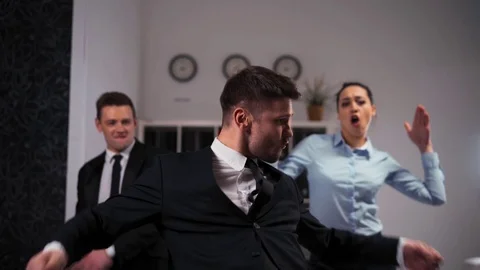 Collegues dancing cheerfully in office in front of the camera. Stock Footage 78950948