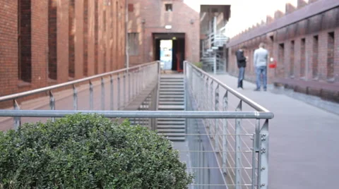 Collegues in the inside courtyard of a red brick building Stock Footage 63548413