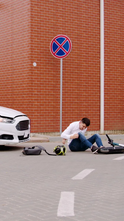 Collision between electric scooter car male driver sustained injuries road Stock Footage 274849086