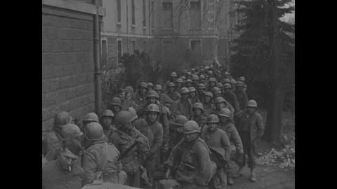 COLMAR - 1945: Line of waiting troops - Waiting soldiers turn toward the camera Stock Footage 344005947